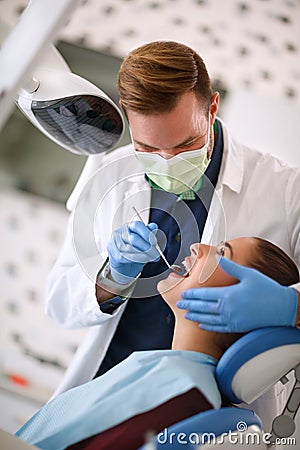 Dentist checking up womanâ€™s teeth Stock Photo